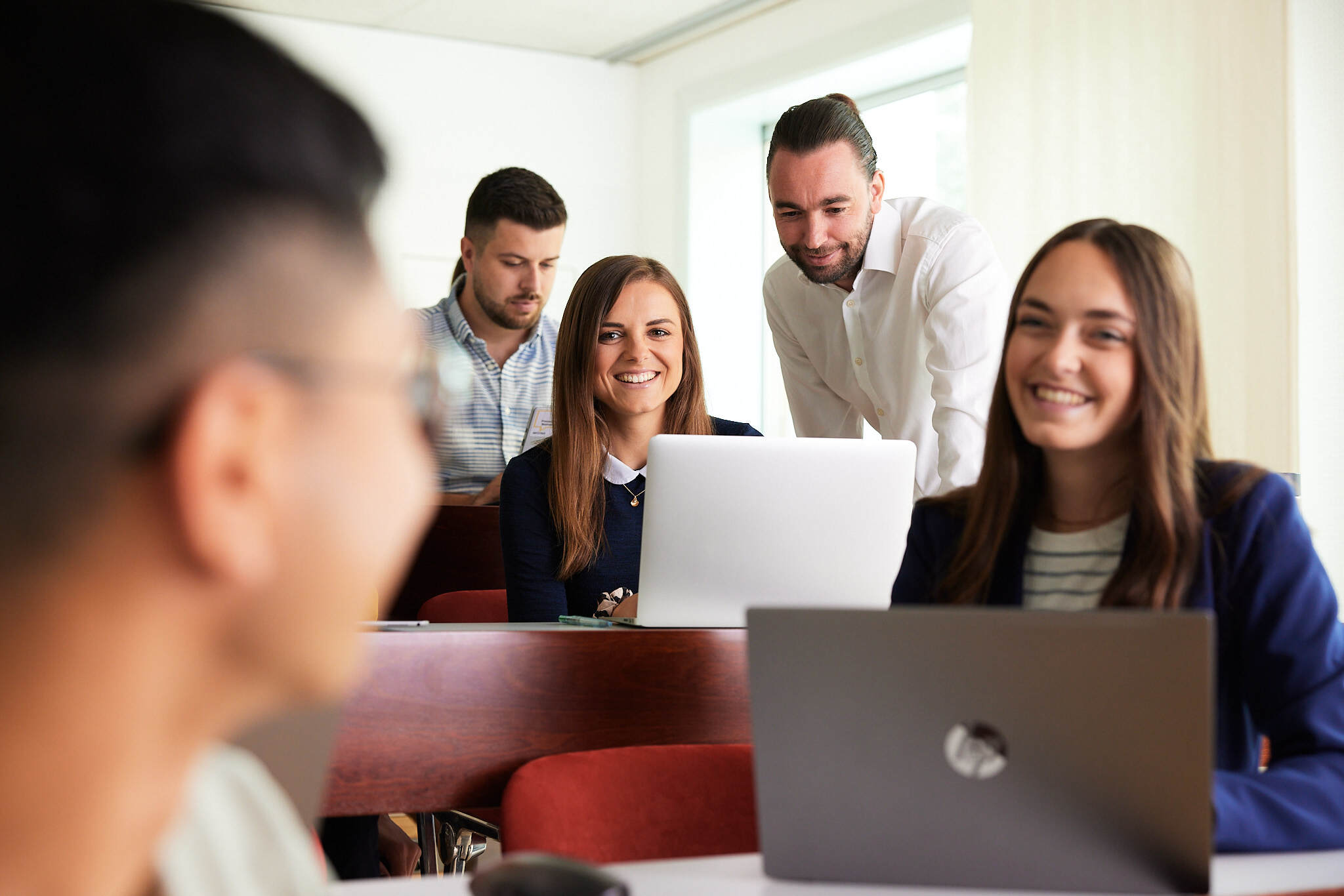 A group of young students sitting in front of their laptops in a lecture hall at Steyr Campus University of Applied Sciences, Austria.